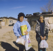 Happy native americans with food and clothe donations
